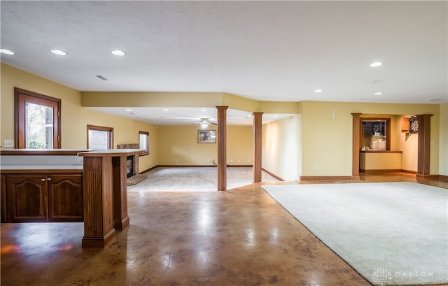 basement featuring ceiling fan and a textured ceiling