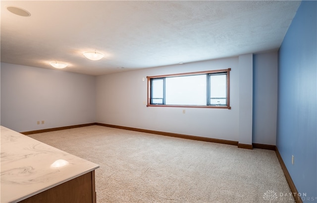 unfurnished room with light colored carpet