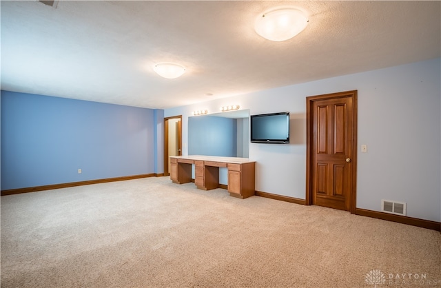 unfurnished living room with light colored carpet