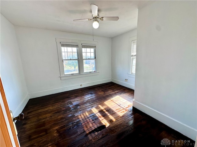 empty room with ceiling fan and dark wood-type flooring