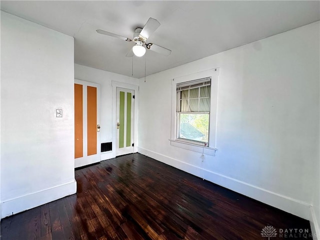 empty room with ceiling fan and hardwood / wood-style floors