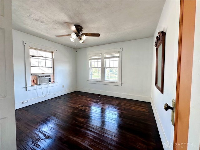 unfurnished room featuring ceiling fan, cooling unit, dark hardwood / wood-style flooring, and a textured ceiling