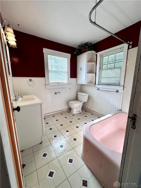 bathroom with tile patterned flooring, vanity, and toilet