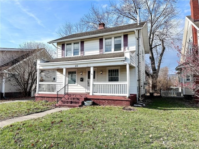 view of front of house with covered porch and a front yard