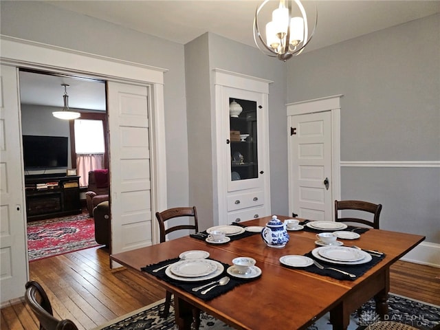 dining space featuring a notable chandelier and hardwood / wood-style floors