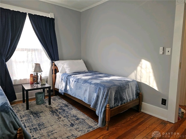 bedroom featuring ornamental molding and dark wood-type flooring