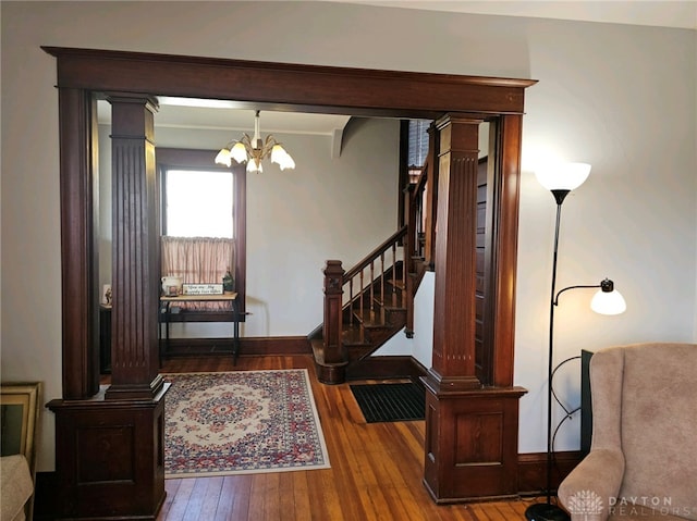 foyer featuring a chandelier, beamed ceiling, and wood-type flooring