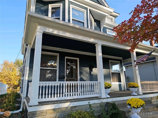 view of exterior entry featuring a porch