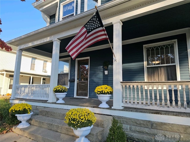 view of exterior entry with covered porch