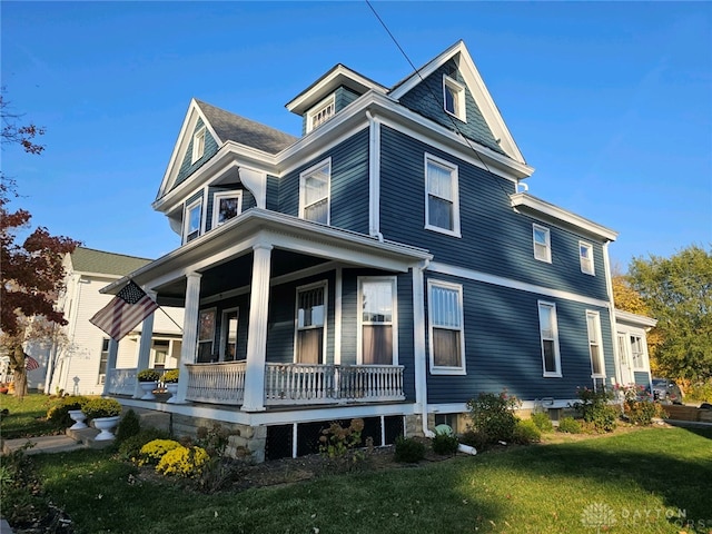 view of front of house with a porch and a front lawn