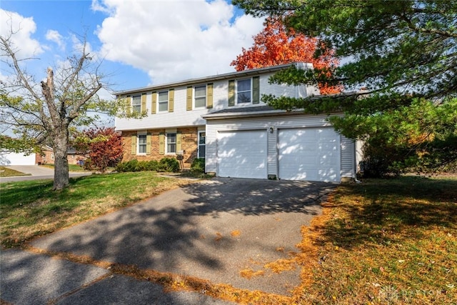 view of front of home with a front lawn, an attached garage, and driveway