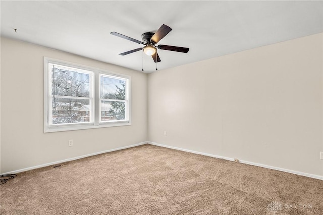 empty room with baseboards, a ceiling fan, and carpet floors