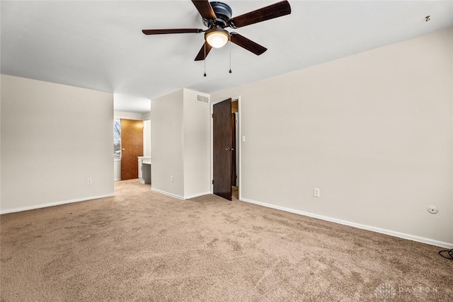 carpeted empty room with a ceiling fan, baseboards, and visible vents