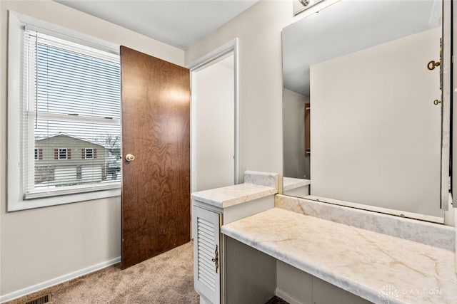 bathroom with baseboards and visible vents