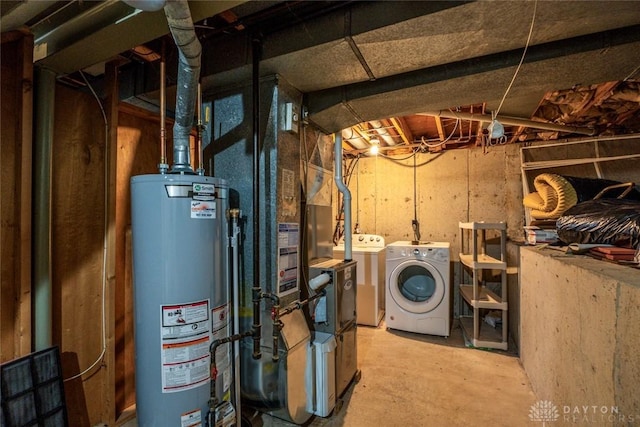 utility room with gas water heater and washing machine and dryer