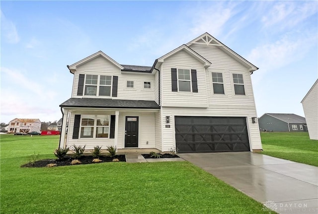 view of front of property featuring a front yard and a garage