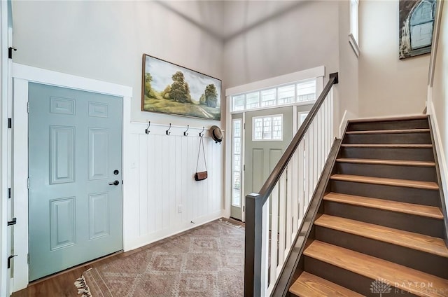 mudroom featuring a towering ceiling