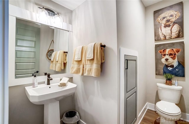 bathroom featuring hardwood / wood-style flooring and toilet