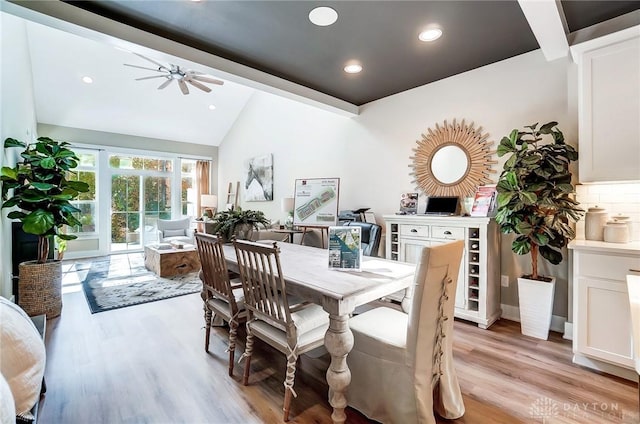 dining room featuring vaulted ceiling and light hardwood / wood-style flooring