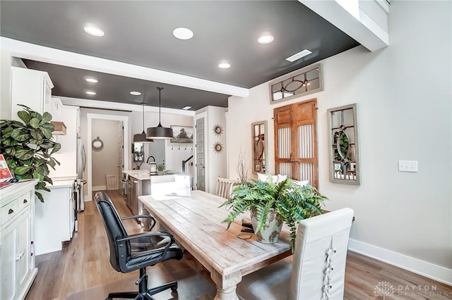 dining space with hardwood / wood-style floors