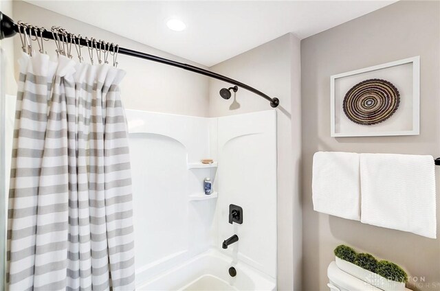 bathroom featuring toilet and shower / bath combo with shower curtain