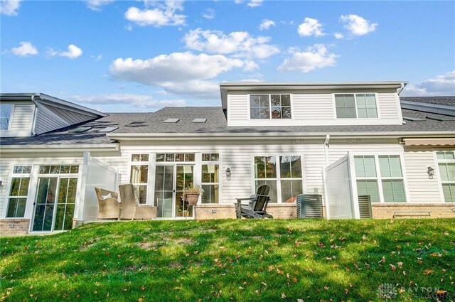 rear view of house with a lawn