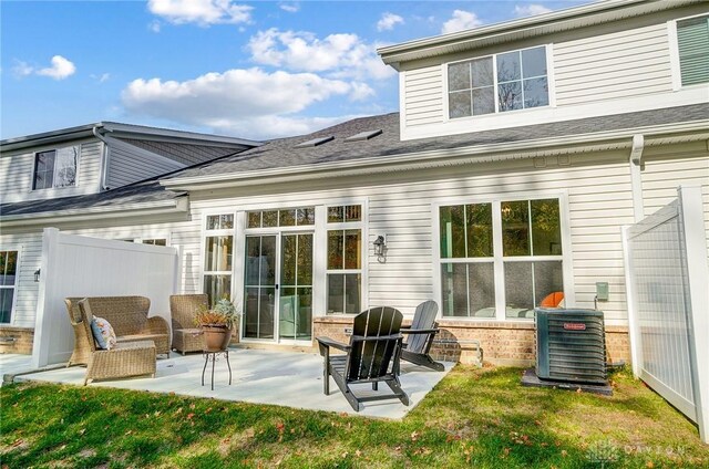 back of house with a yard, a patio, and central air condition unit