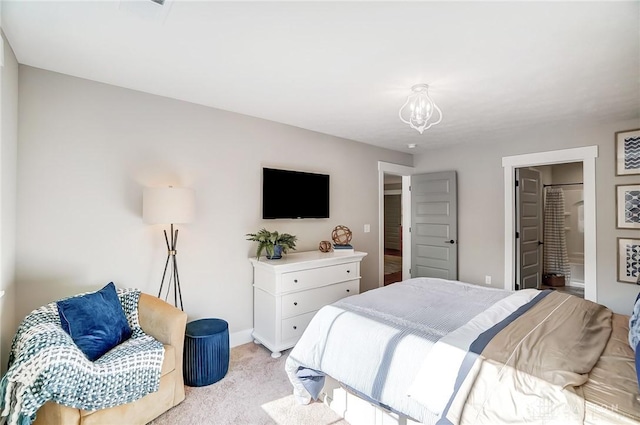 carpeted bedroom with a notable chandelier