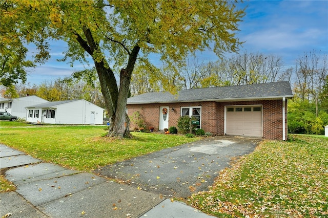 ranch-style home featuring a garage and a front lawn