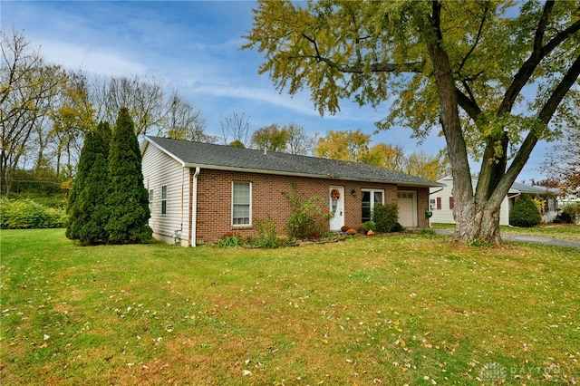 ranch-style house with a garage and a front lawn