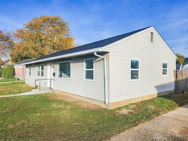 view of side of home featuring a yard