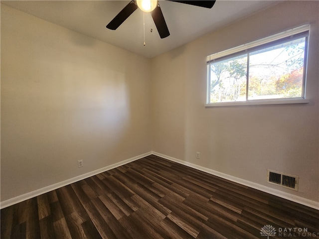 spare room featuring ceiling fan and dark hardwood / wood-style flooring