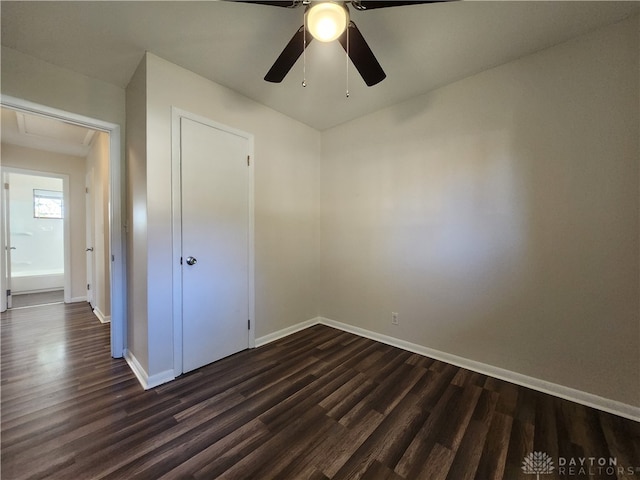 unfurnished bedroom with a closet, dark wood-type flooring, and ceiling fan