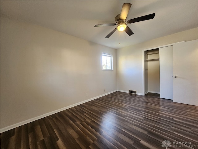 unfurnished bedroom featuring dark hardwood / wood-style flooring, a closet, and ceiling fan