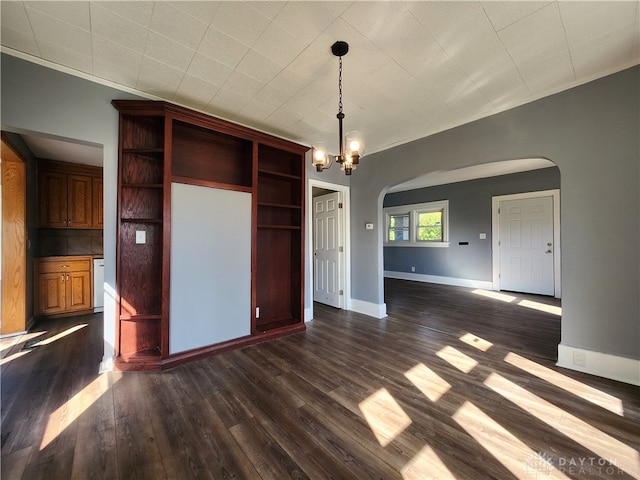 interior space with hanging light fixtures, a chandelier, and dark wood-type flooring