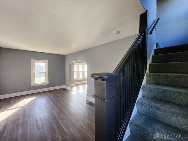 stairs featuring hardwood / wood-style floors