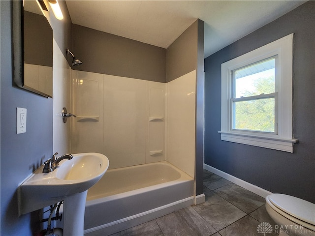 bathroom with toilet, tile patterned floors, and shower / bathing tub combination