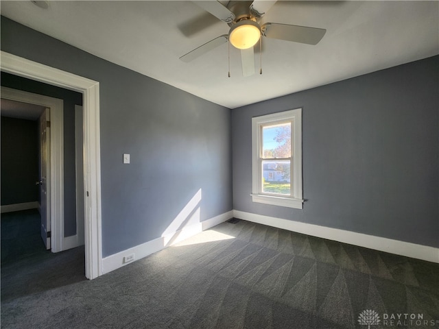 carpeted spare room featuring ceiling fan