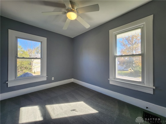 spare room featuring ceiling fan and carpet floors