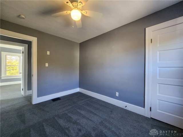 carpeted spare room with ceiling fan