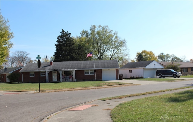 ranch-style home with a front lawn and a garage