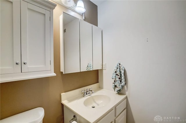 bathroom featuring vanity and toilet