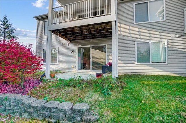 back of house featuring a patio and a yard