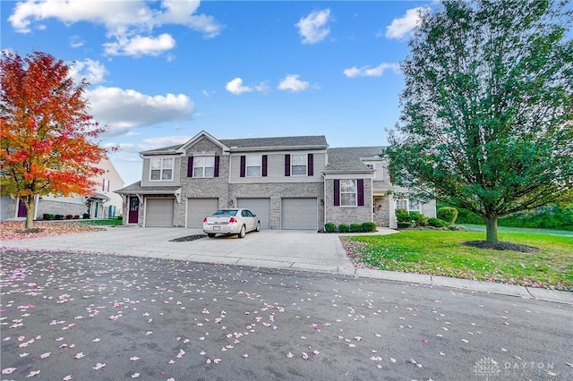 view of front of house featuring a garage and a front lawn