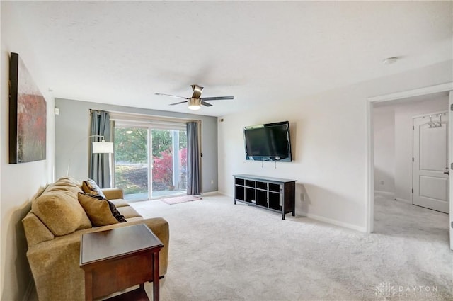 living room with ceiling fan and light carpet