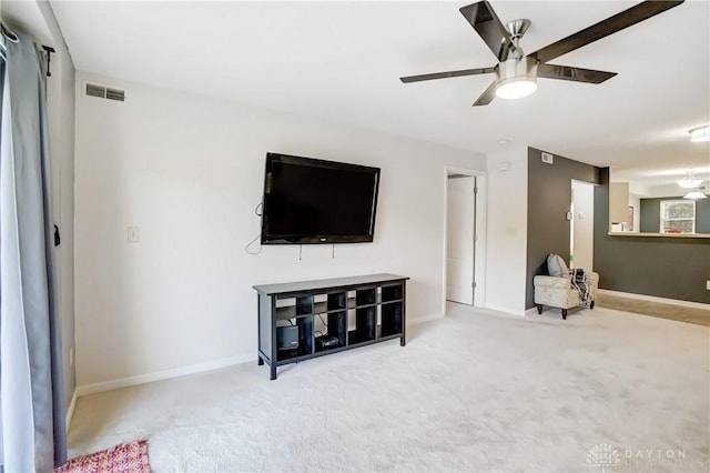 living room featuring light colored carpet and ceiling fan