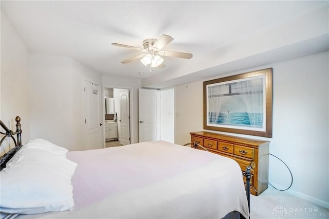 bedroom with light carpet, ensuite bath, and ceiling fan