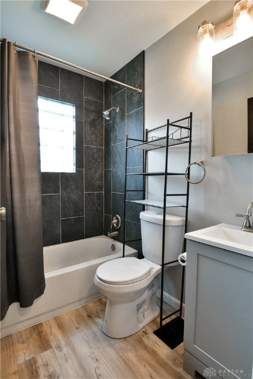 full bathroom featuring vanity, shower / tub combo with curtain, hardwood / wood-style flooring, and toilet