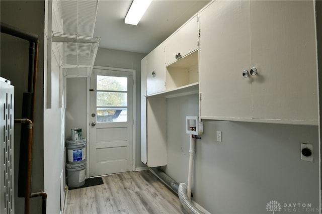 washroom with hookup for a washing machine, electric dryer hookup, and light wood-type flooring