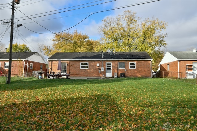 rear view of property with a yard and a patio